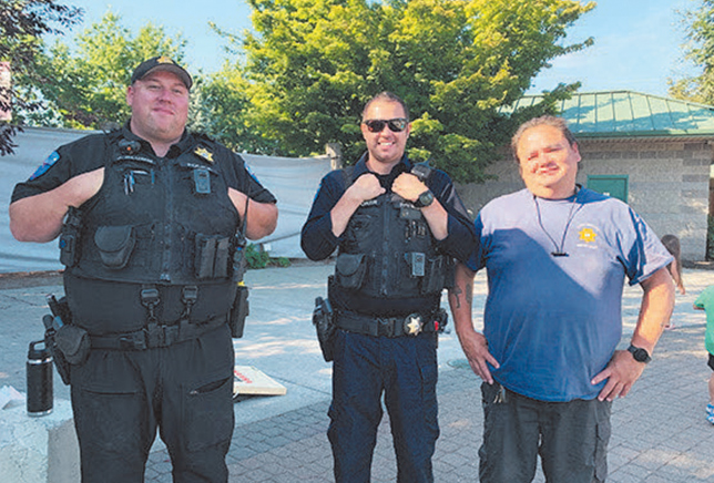 Three officers from Tulalip Police Department standing together at the park. 